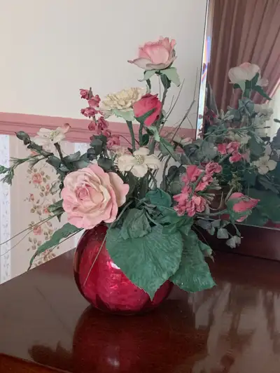 Beautiful round rose colored glass vase with dried flowers