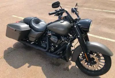 Here is a 2018 HD Road King Special. Very low mileage. Belt drive. Cruise control. Integrated saddle...
