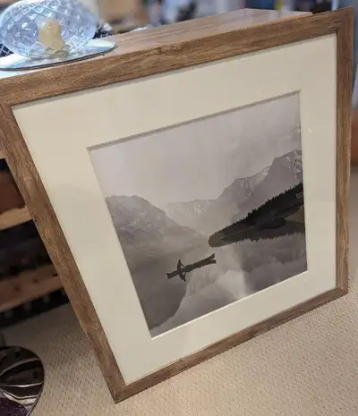 This beautiful black and white picture shows a canoe on Lake Minnewanka in Banff National Park. The...