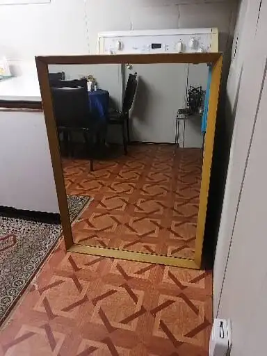 Wooden framed mirror hangs up, View more
