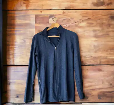 NWOT Tuff Athletics full zippered yoga jacket in a beautiful deep blue. It has the signature logo on...
