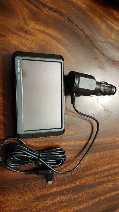 Navigate your way with this used Garmin Nuvi GPS navigator, complete with a car charger, ensuring yo...