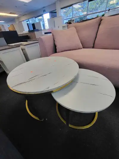 These brand new nesting coffee tables offer a modern touch with their faux marble tops and gold-tone...