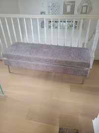 Grey upholstered bench with metal legs