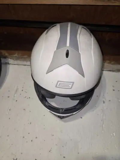 This is a white and grey, used motorcycle helmet. Here are some additional details: * Colour: White...