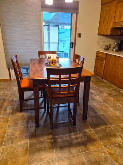 A dining room table and chair set for sale. The table has 8 chairs. The middle section of the table...
