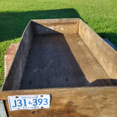 Utility trailer, 4' x 8' plywood box. Steel frame tips for easy load unload. Needs lights