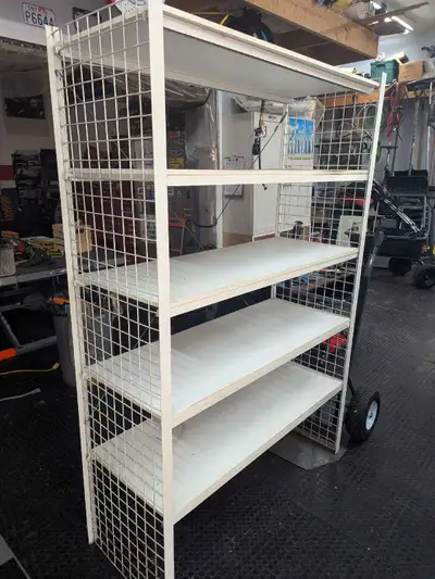 This is a used shelving unit with 5 shelves, ideal for organizing items in a garage, storage room, o...