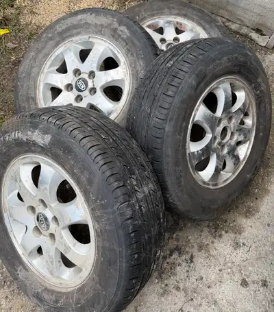 (Pictures 1-5) (4)- 215/70r15 All Season tires in Alloy rims 5x114.3 Bolt pattern, 67.1mm Centre bor...