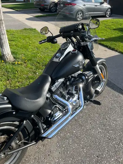 Get ready to experience the road on this sleek, black 2013 Harley Davidson Fat Boy Lo, a true icon o...