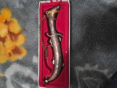 brass-colored souvenir dagger featuring a horse-head handle, View more