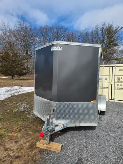 2025 EZ hauler aluminum trailer. 7x14, rear drop down door, side door and spare tire. Aluminum frame...