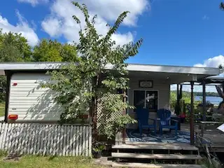 This 30 ft trailer (sleeps 5-6) and attached sunroom (10x20) offers a cozy and spacious retreat, per...