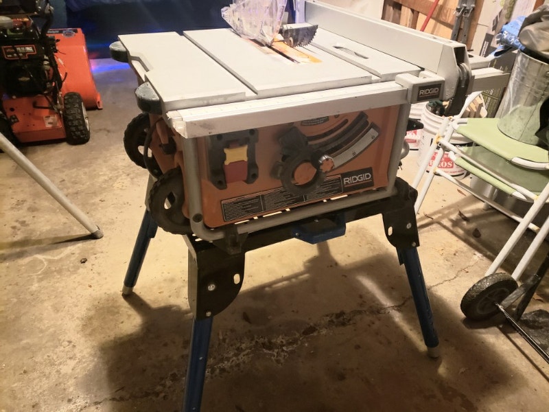 Rigid table saw with wheeled base and carrying handle. Table not