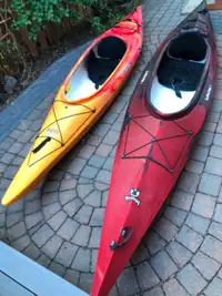 Pair of Clearwater Design kayaks with Thule car rack and paddles