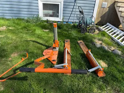 Durable Norwood PortaMill chainsaw sawmill attachment is orange metal with adjustable height scale....