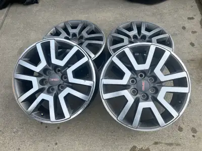 Set of 4 OEM GMC aluminum wheels in the factory machined Denali finish (silver spokes with dark pock...