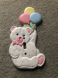 Decorative light switch plate for a baby's room