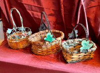 Three wicker baskets with metal handles