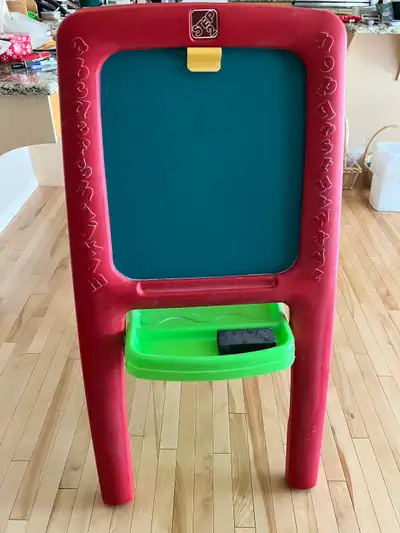 Step 2 toy easel has a whiteboard on one side and a chalkboard on the other. Whiteboard side is magn...
