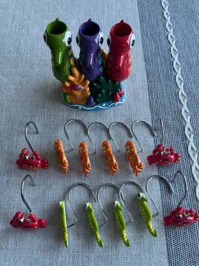 Ocean themed shower curtain rings and toothbrush holder in great shape.