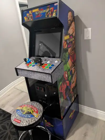 Selling a mint condition arcade 1up Marvel vs Capcom 2 arcade with riser and stool. Marquee also lig...