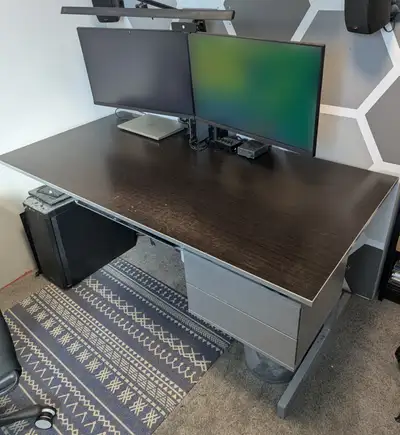 Ikea Jerker computer desk with grey steel frame and black laminated particle board top with grey tri...