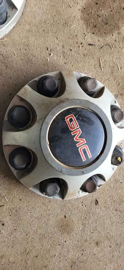 These are GMC center caps that came off of a 2015 . They are in used condition, showing signs of wea...