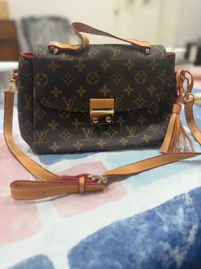 This is a Louis Vuitton bag in used condition. Perfect to carry all your prized possessions. Specifi...