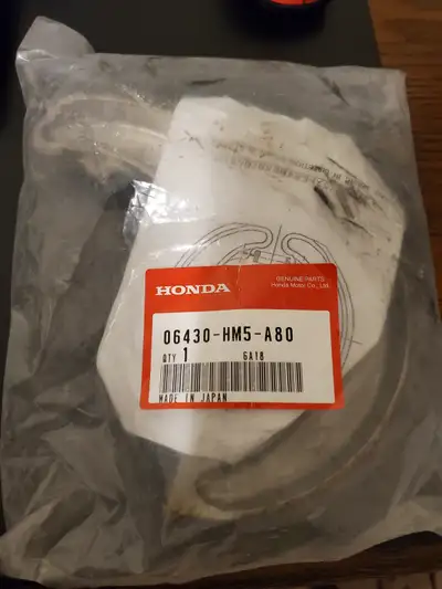 The Honda part number 06430-HM5-A80 refers to a genuine OEM rear brake shoe set, including springs,...