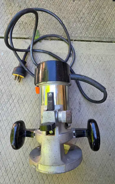 This is a used Craftsman router, perfect for woodworking projects. It comes with a table attachment...