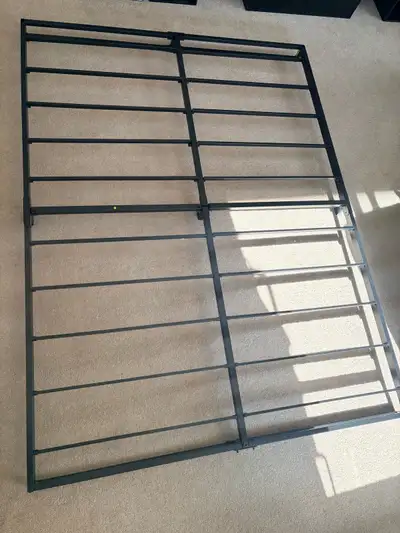 This sturdy black metal bed frame provides reliable support for your mattress, offering a clean and...