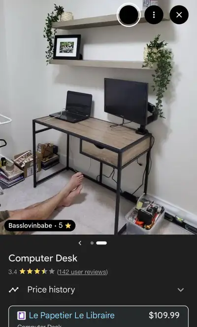 This computer desk features a sleek design with a wood-grain top and a sturdy black metal frame has...