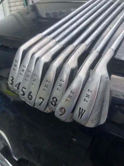 For sale is a set of TNT Custom golf irons, perfect for any golfer looking to improve their game. Th...