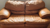 Tan leather love seat