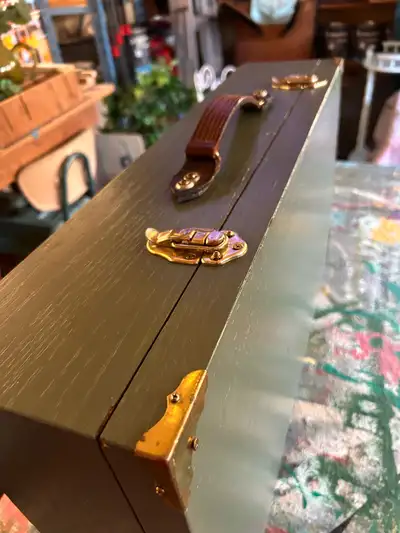 This piece has a nice weathered leather handle and brass hardware. Looks to be all wood. It’s a love...