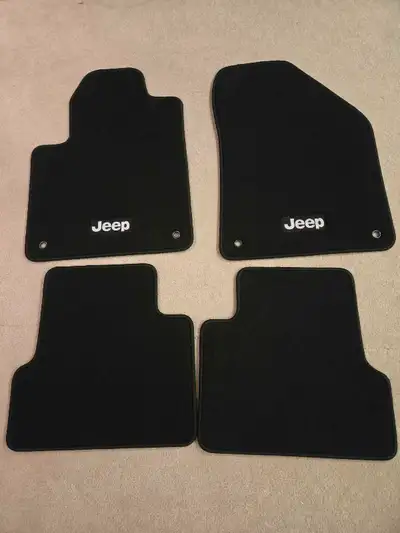 New genuine OEM black carpet floor mats are for a Jeep Cherokee (KL model). They provide a perfect,...