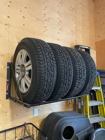 235/65R18 Cadillac Rims, with studded tires 2 years old, like new,