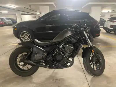 Modified rear fenders, mirrors and exhaust pipes. Two leather bags were added to provide storage spa...