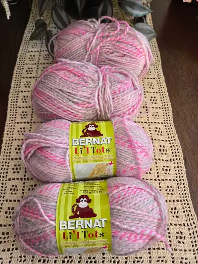 Four skeins of Bernat Li'l Tots yarn, perfect for your next cozy project! This soft, medium weight y...