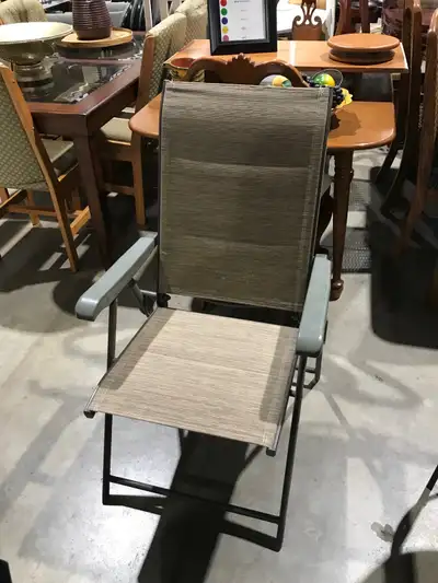 This is a used folding chair with a brown fabric seat and back, and grey armrests and frame. It's in...