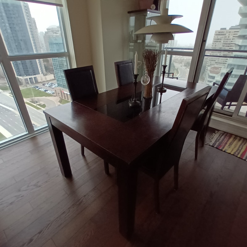Dark wood Dining Table with black glass table top, 4 chairs. Dining