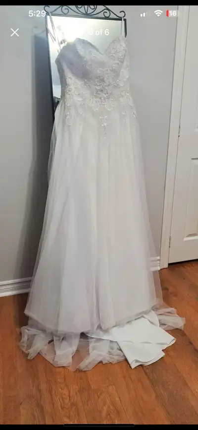 A beautiful white wedding dress worn once. Size 12