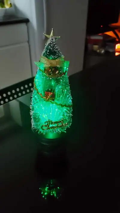 Add a festive glow to your holiday decor with this charming, small, battery-operated Christmas tree,...