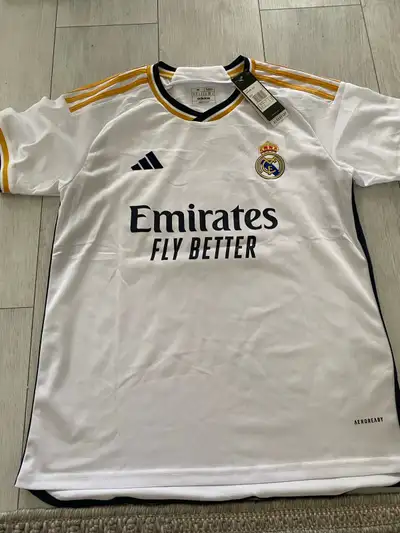 Get ready to show your support with this brand new Adidas Real Madrid 2023/24 home jersey, featuring...