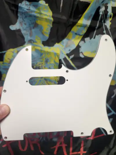 White and off white 8 hole original Fender 3 ply Tele pickguards. White plate still has plastic on i...