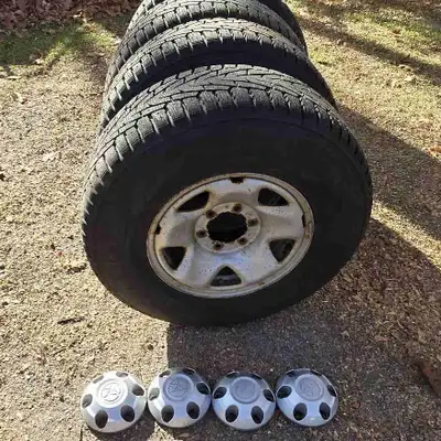 Pneus hiver Nokian Nordman 7 cloutés 245/75 R16 sur roues d'acier d'origine avec couvercles de moyeu...