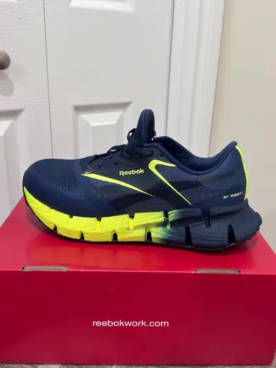 Step into safety with these brand new Reebok FloatZig CSA safety shoes, size 10, designed for ultima...