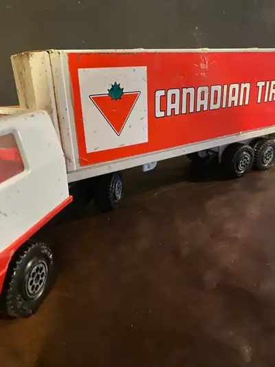 This is a large, used Canadian Tire Metal Tonka Truck, perfect for collectors or as a nostalgic toy....