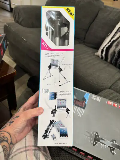 This is a new 201 Tablet Tripod that can be used to read an iPad anywhere you want to be, at any ang...